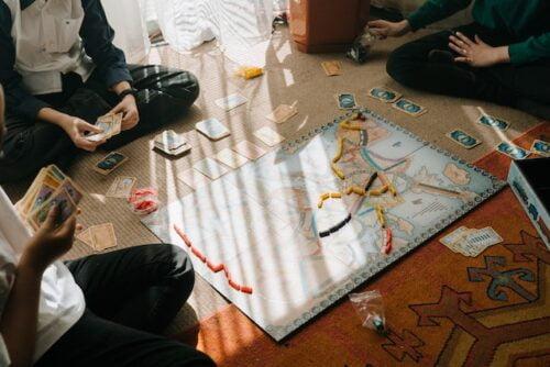 Are board games making a comeback, people playing a board game on the floor