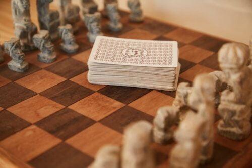 Board games vs card games, a board of chess with cards