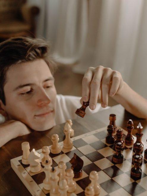 Board games you can play by yourself, a man playing chess by yourself