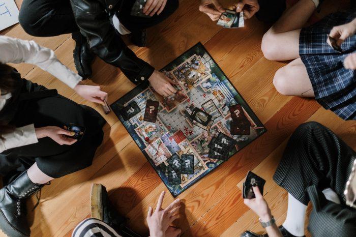 How Big is the Board Game Industry Exploring Its True Size, people playing a board game on the floor