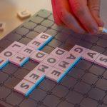 Popular Board Games for Adults Find the Most Fun Options, someone playing scrabble